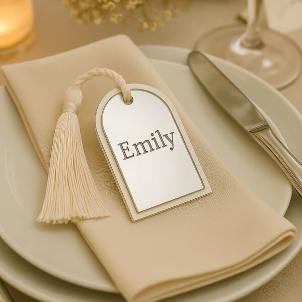 Silver name card engraved with guest name in serif font